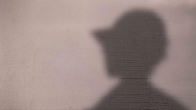 Silhouette of a woman (shade on white wall)
