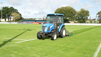 A tractor tends to the playing surface at Jersey Reds