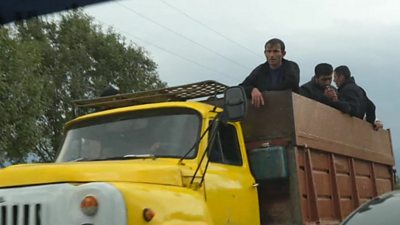 Refugees in yellow truck