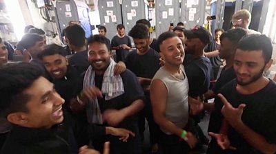 Migrants smiling and dancing
