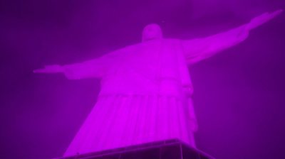 Pink light shines on Christ the Redeemer statue