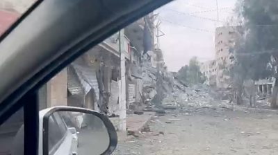 Demolished building seen through car window