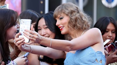 Taylor Swift taking selfie with fan
