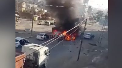 Cars on fire after a missile strike on convoy of civilians