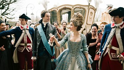 Still from Marie Antoinette of Louis XVI and Marie walking from a carriage with people cheering. they look at each other adoringly 