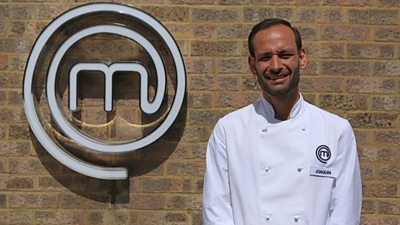 Man wearing chefs shirt in front of MasterChef M
