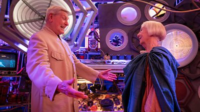 Peter Purves and Maureen O'Brien in Tales of The TARDIS. They stand smiling in the special TARDIS.