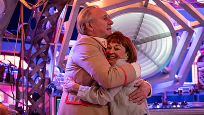 Peter Davison and Janet Fielding hug in Tales of The TARDIS