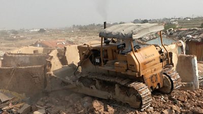 Bulldozer knocks down walls at refugee camp