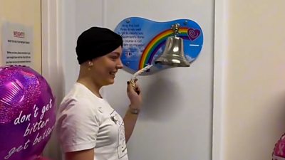 Amy Dowden ringing a cancer bell in a hospital