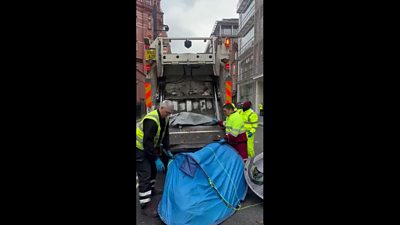 Veolia workers place tents in bin lorry