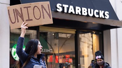 Steph Kronos, a pro-Union activist, on strike outside a Starbucks