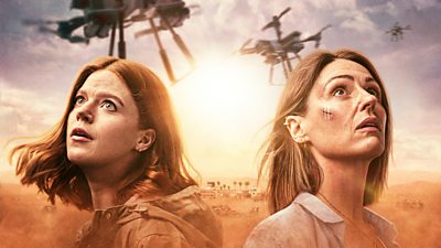 DI Kirsten Longacre (Rose Leslie) and DCI Amy Silva (Suranne Jones) are pictured looking up to the sky, where drones are flying