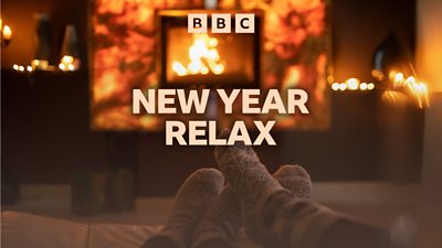 Artwork for 鶹Լ Sounds’ New Year Relax featuring a cosy living room with a fireplace. Two pairs of feet in warm socks point towards the fire. 