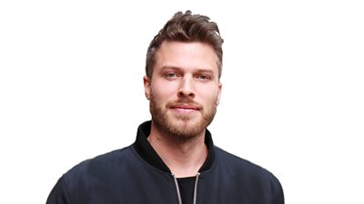 Headshot of presenter Rick Edwards smiling to camera. 