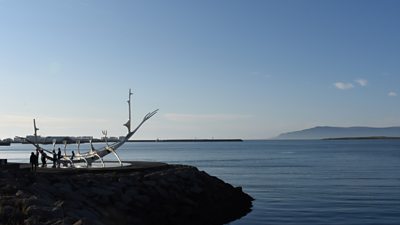 Image of a coastline with the sea stretching into the distance. 