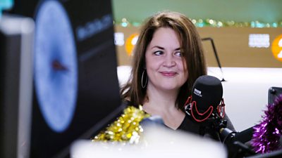 Picture of Ruth Jones sat next to a microphone in a 鶹Լ Radio studio. 