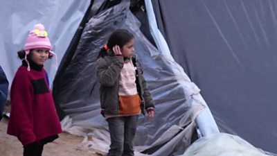 Little girls next to tent