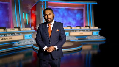 Amol Rajan stands on set for Christmas University Challenge