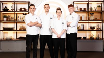 Four chefs wearing MasterChef branded shirts in the MasterChef kithen
