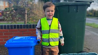 Samuel helps his dad put the bins out the night before