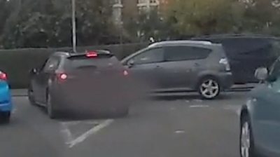 Car has a near-miss while being followed by a police car.