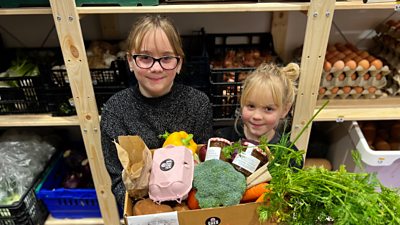 Laurel and Rosie hold one of their veg boxes