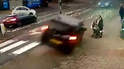 CCTV captures a car mounting pavement, turning over and hurtling at the pedestrian and her pushchair.