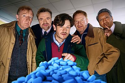 Colin White (STEFFAN RHODRI), Tommy Cadogan (PAUL RHYS), Meurig Jenkins (IWAN RHEON), Eddie O’Connor (MARK LEWIS JONES), Peetham ‘Pete’ Shah (PHALDUT SHARMA) in Men Up (Credit: 鶹ҳ/Quay Street Productions/Aiistair Heap)