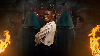 Jasmine stands in front of two cloaked figures outside the castle at night. Flames burn on either side of them and black crows fly in the background.