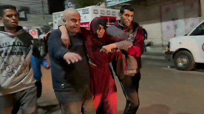 Injured woman being walked to hospital in Rafah