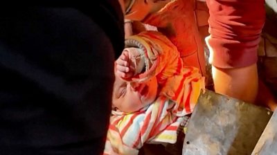 Baby being pulled from rubble