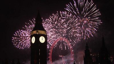 Elizabeth Tower and London Eye lit up by fireworks