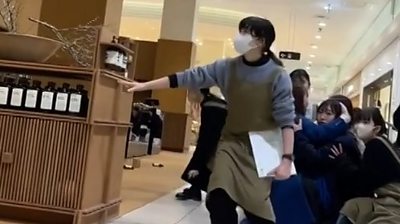 People crouch inside shopping mall during earthquake in Japan