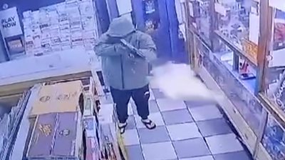 Man with gun in newsagents