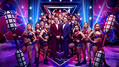 Group photo featuring the 16 Gladiators, two hosts (Bradley and Barney Walsh), and three referees for the new series. The group pose for the camera in front of branding for BBC Gladiators.