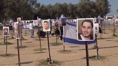 Posters showing pictures of people killed or kidnapped by Hamas at the Nova Music Festival site on October 7 2023.