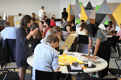 Group of people looking at papers around a table