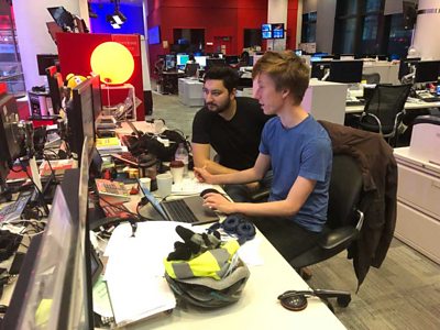Tom Francis-Winnington and Joe Whitwell at a computer in the BBC Newsroom