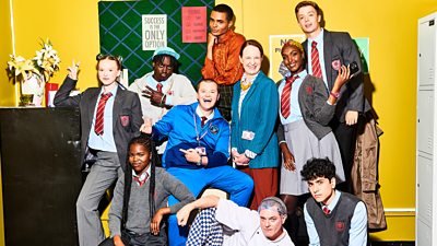 Ten characters from Bad Education pose for the camera, including teachers, students and kitchen staff. 