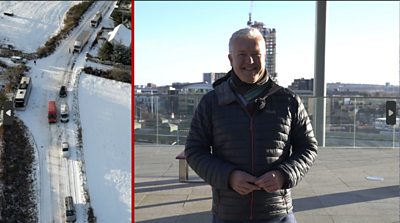 Derek standing outside with a snowy road picture beside him