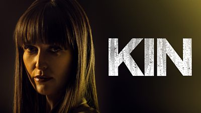 A woman stares down the lens of the camera. Kin is written in large block capital letters.