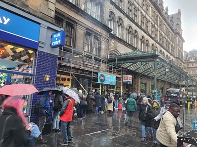 People queue outside Glasgow Central Station.