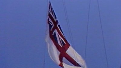 White ensign flag being lowered at Chatham Dockyard