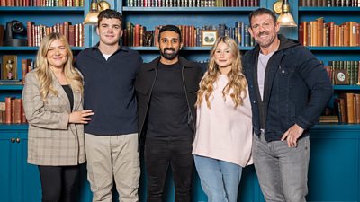 Left to right: Evie, Harry, Jaz, Mollie and Andrew stand with their arms around each other in the castle library