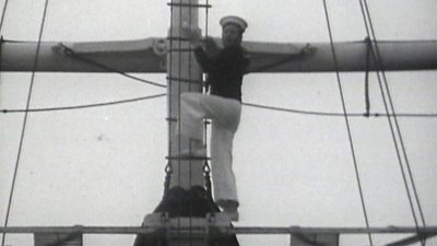Blue Peter presenter John Noakes climbs to the top of the mast of HMS Ganges at Shotley Gate.