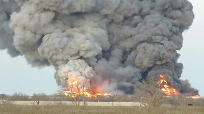 Huge flames and clouds of smoke are seen as firefighters tackle a blaze at a farm in Bryan.