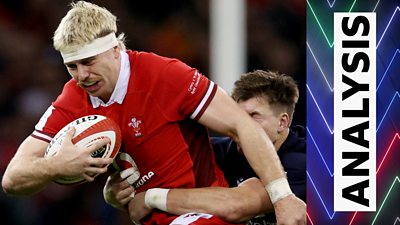 Aaron Wainwright of Wales is tackled by Huw Jones of Scotland