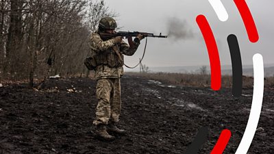 A Ukrainian soldier fires a rifle