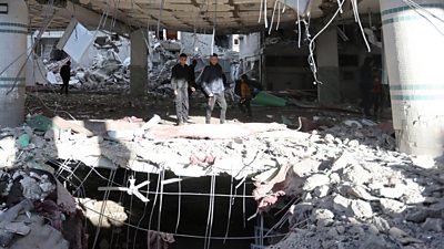 Palestinians inspect the site of an Israeli strike on a mosque in Rafah in the southern Gaza Strip, on 12 February 2024